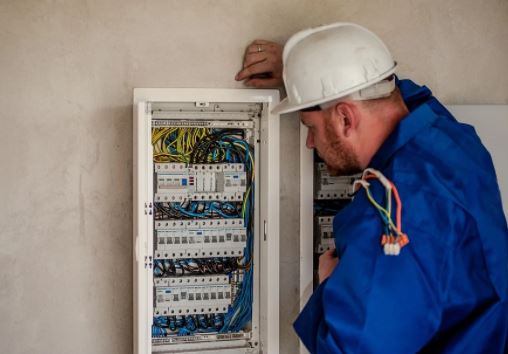 Figure 9 Electrician working on a circuit breaker