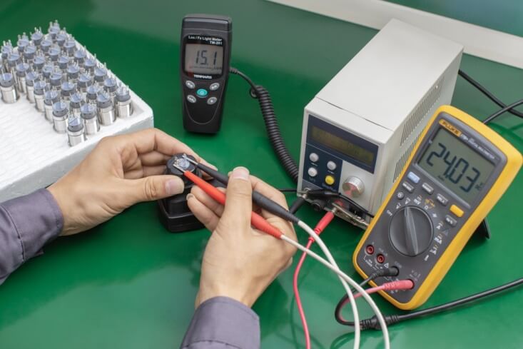 Manufacturer testing a batch of push button switches